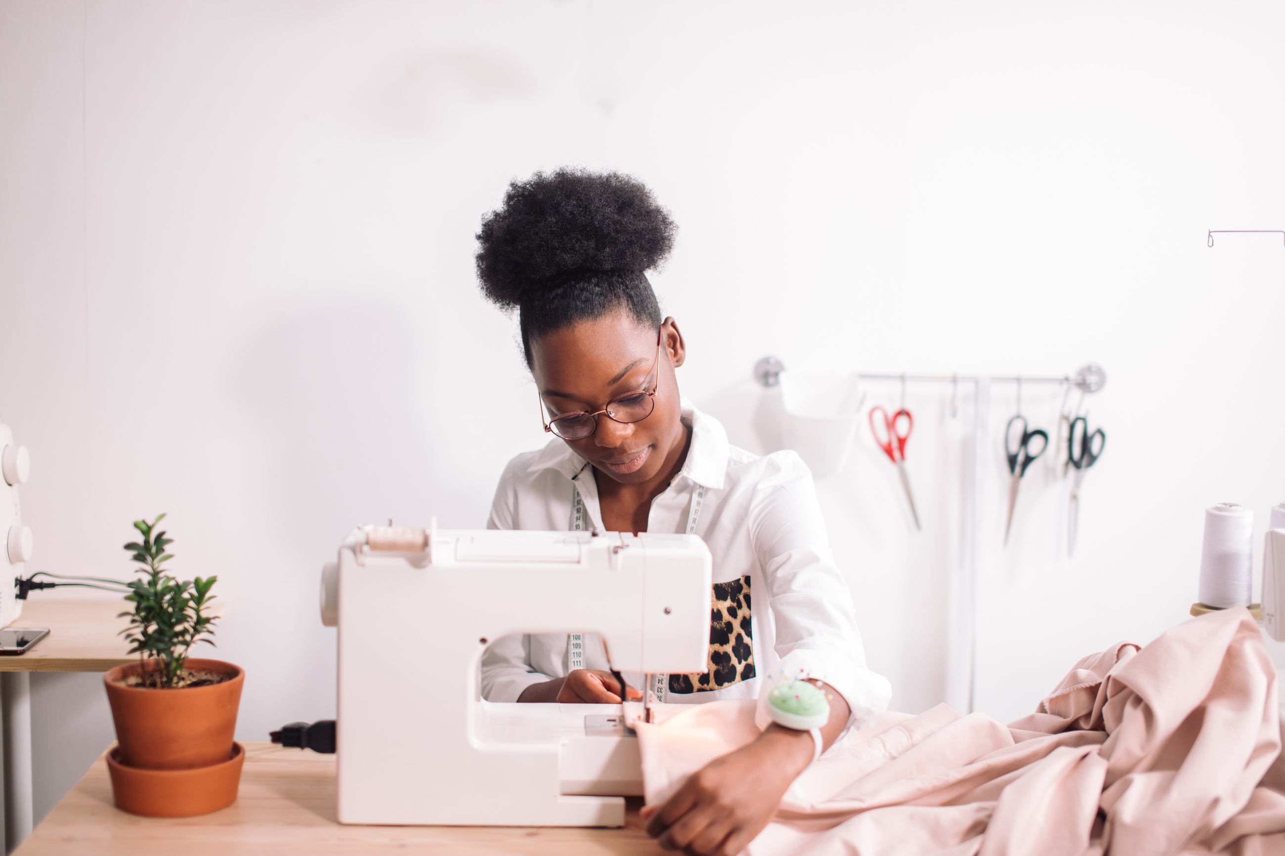 african seamstress sews clothes